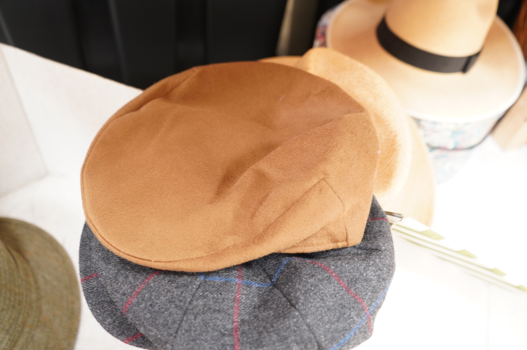 Two hat boxes containing five gentleman's hats; three Fedoras by Locke, Christy’s and Herbert Johnson and two straw Panamas, one by Bates.